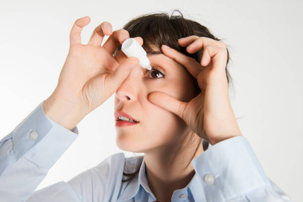 A young using eyedrop